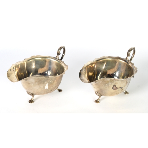 506 - PAIR OF GEORGIAN STYLE SILVER SAUCE BOATS BY C W FLETCHER & SON Ltd, each with high scroll handl... 