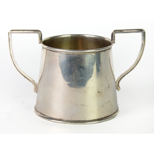 430 - GEORGE V SILVER TWO HANDLED SUGAR BOWL, of plain tapering form with angular scroll handles, 2 ¾” (7c... 