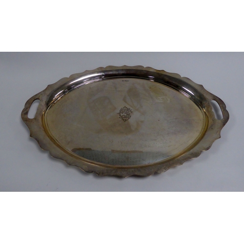 437 - INTER-WAR YEARS SILVER TRAY with scalloped edge and pierced handles, the centre with engraved monogr... 