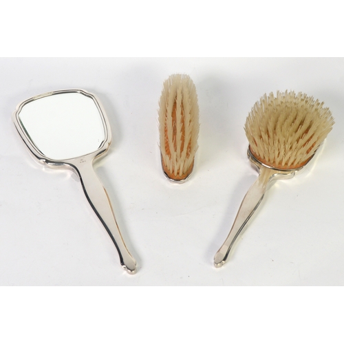 442 - THREE PIECE ENGINE-TURNED SILVER-BACKED LADY'S DRESSING TABLE BRUSH SET of hand mirror, hair brush a... 