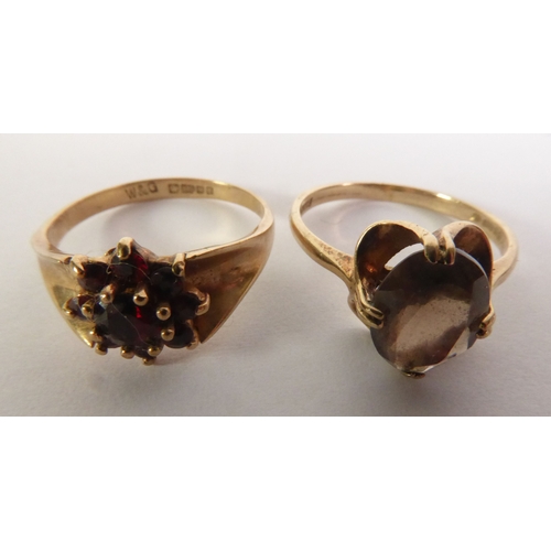 342 - 9ct GOLD RING, set with an oval citrine and a 9ct GOLD RING set with a cluster of garnets, 5gms tota... 