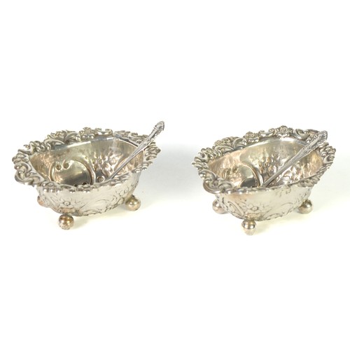 387 - PAIR OF VICTORIAN SILVER OVAL SALT RECEIVERS, repousse with flowers and rococo scrolls on the outsid... 