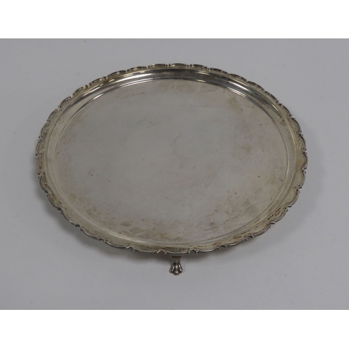 371 - GEORGE VI SILVER SALVER BY HUTTON & SONS, with plain centre, raised border and paw feet, 12” (30... 