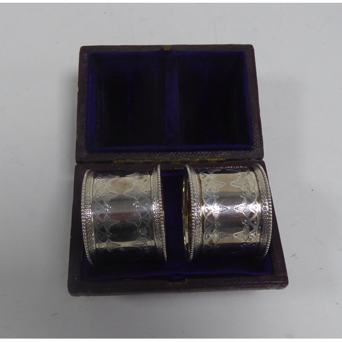 466 - CASED PAIR OF VICTORIAN ENGRAVED SILVER NAPKIN RINGS BY WALTER & JOHN BARNARD, London 1877, 1.85... 