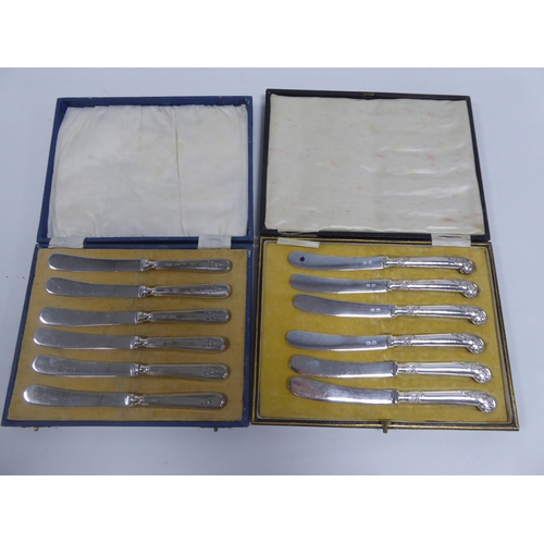 478 - TWO CASED SETS OF SIX AFTERNOON TEA KNIVES WITH FILLED SILVER HANLDES, one set with pistol grip hand... 