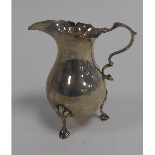 507 - GEORGE V SILVER CREAM JUG BY MAPPIN & WEBB, of baluster form with acanthus capped double scroll ... 