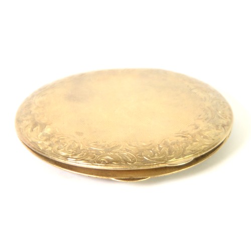 124 - GOLD PLATED CIRCUAR POWDER COMPACT, engine turned with foliate scroll engraved broad border and cent... 