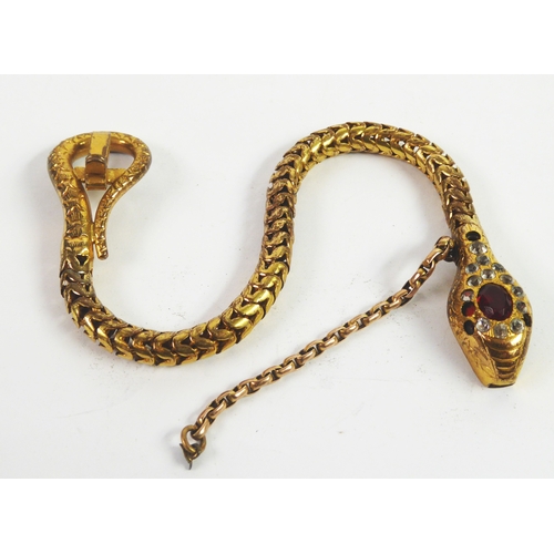 59 - VICTORIAN GOLD PLATED ARTICULATED BRACELET in the form of a snake, the head set with red and white p... 