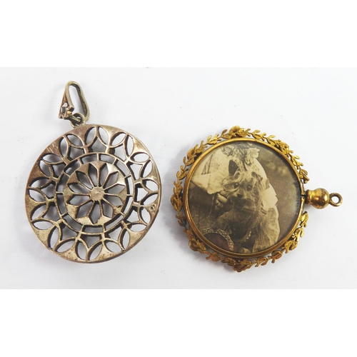 62 - VICTORIAN GOLD COLOURED METAL CIRCULAR PHOTOGRAPH LOCKET PENDANT, glazed both sides, the foliate fra... 