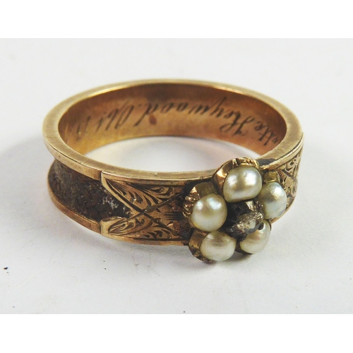 90 - VICTORIAN GOLD COLOURED METAL MOURNING RING, set with a cluster of five seed pearls, the shank inset... 