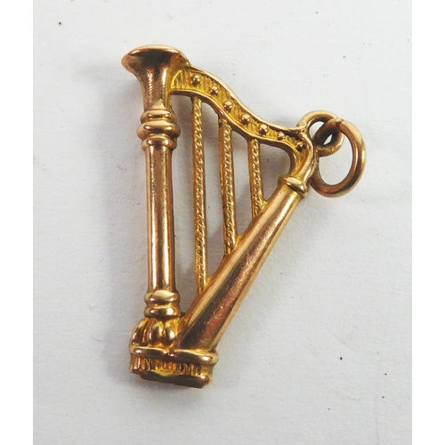 106 - 9ct GOLD PENDANT in the form of a harp, 7/8in (2.2cm) high, 1.1gms