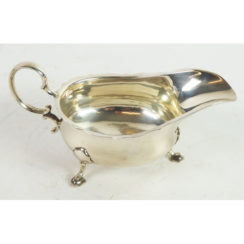 253 - GEORGE V SILVER SAUCE BOAT BY MAPPIN & WEBB, of typical form with high scroll handle, cyma borde... 