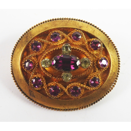 115 - VICTORIAN GOLD PLATED OVAL TARG BROOCH, set with foil-backed stones, viz an oval amethyst coloured s... 