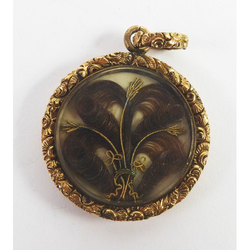 94 - VICTORIAN GOLD COLOURED METAL CIRCULAR PENDANT, the back engine turned, the glazed locket front encl... 