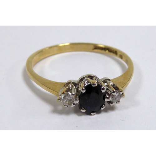 178 - 9ct GOLD RING, claw set with a centre oval sapphire, flanked by two small round brilliant cut diamon... 