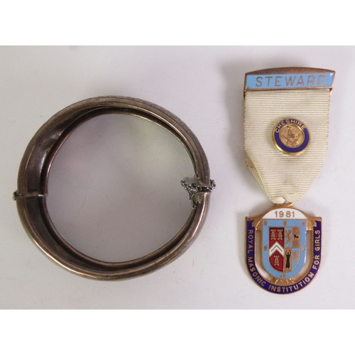 84 - ROYAL MASONIC INSTITUTION FOR GIRLS 1981 STEWARD BADGE AND RIBBON, and A SILVER HINGE OPENING BANGLE... 