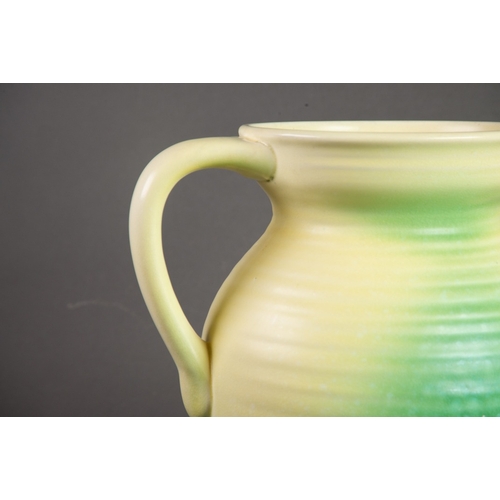 21 - ROYAL CAULDON POTTERY LARGE JUG, of ribbed form with loop handle, glazed in fading tones of yellow a... 