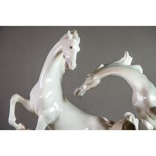 148 - LARGE LLADRO-SPAIN PORCELAIN GROUP DEPICTING THREE HORSES FIGHTING sculpted by Fulgencio Garcia circ... 