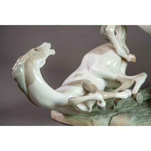 148 - LARGE LLADRO-SPAIN PORCELAIN GROUP DEPICTING THREE HORSES FIGHTING sculpted by Fulgencio Garcia circ... 