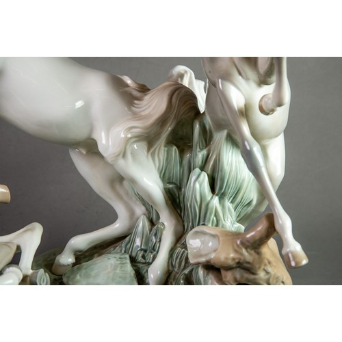 148 - LARGE LLADRO-SPAIN PORCELAIN GROUP DEPICTING THREE HORSES FIGHTING sculpted by Fulgencio Garcia circ... 