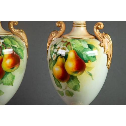 84 - PAIR OF EARLY TWENTIETH CENTURY ROYAL WORCESTER HAND PAINTED TWO HANDLED PEDESTAL CHINA VASES SIGNED... 