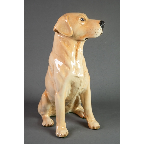 65 - PROBABLY BESWICK, POTTERY MODEL OF A SEATED LABRADOR, 13” (33cm) high, green baize stuck to the base... 