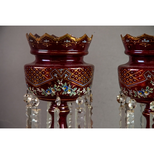 230 - PAIR OF RUBY GLASS TABLE LUSTRES, each of typical form with wavy rims and prism cut glass drops, pai... 