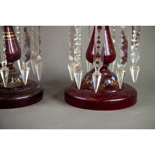 230 - PAIR OF RUBY GLASS TABLE LUSTRES, each of typical form with wavy rims and prism cut glass drops, pai... 