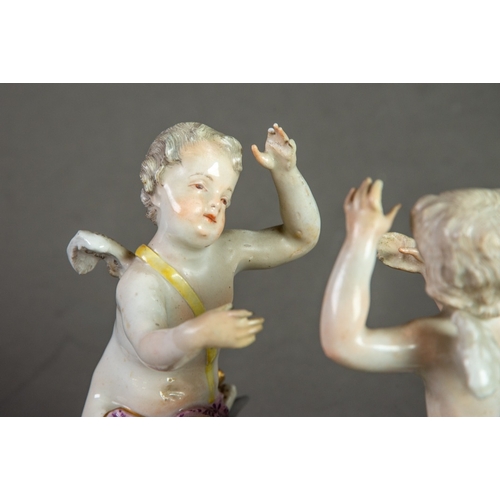 154 - 19th CENTURY MEISSEN PORCELAIN GROUP OF TWO CHERUBS, each seated on the rococo embossed white base, ... 