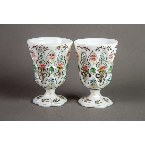 210 - PAIR OF NINETEENTH CENTURY HAND PAINTED AND MOULDED MILK GLASS GOBLETS, each of typical form with pe... 