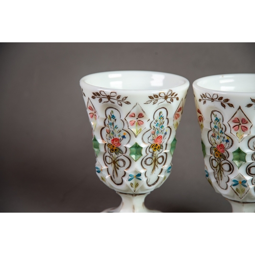 210 - PAIR OF NINETEENTH CENTURY HAND PAINTED AND MOULDED MILK GLASS GOBLETS, each of typical form with pe... 