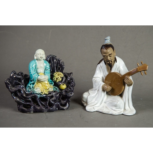 174 - CHINESE 20th CENTURY SEATED FIGURE OF A MUSICIAN playing a lute and having glazed robe and brown bis... 