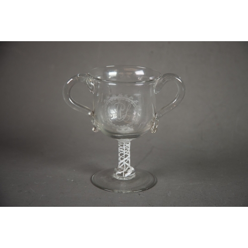 245 - ANTIQUE OPAQUE TWIST TWO HANDLED GLASS LOVING CUP, of typical form with scroll handles, the stem wit... 