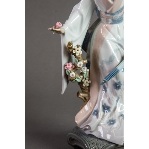 144 - LLADRO ‘TERUKO’ PORCELAIN FIGURE OF A GEISHA, modelled holding a folded parasol and picking flowers,... 