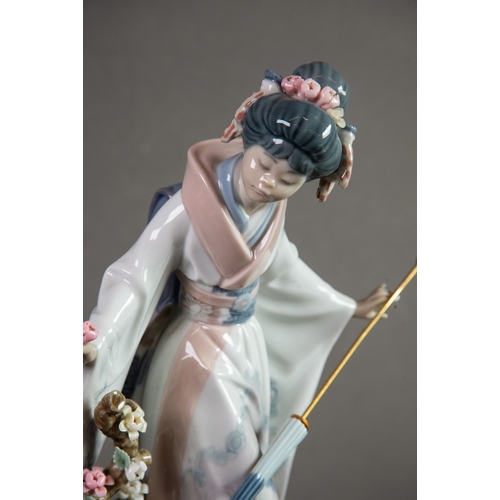 144 - LLADRO ‘TERUKO’ PORCELAIN FIGURE OF A GEISHA, modelled holding a folded parasol and picking flowers,... 