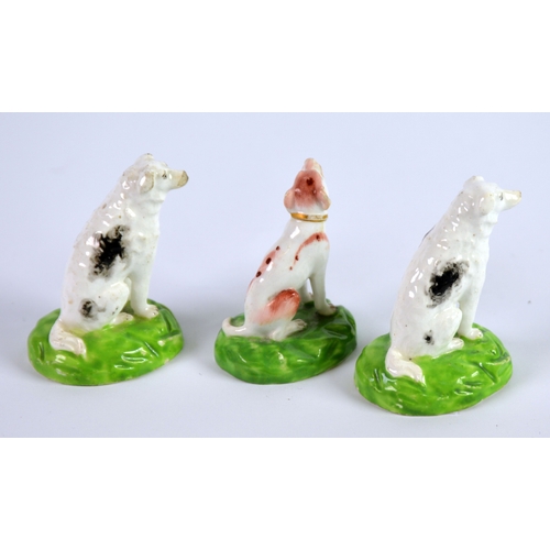 131 - THREE NINETEENTH CENTURY STAFFORDSHIRE PORCELAIN MODELS OF SEATED DOGS, including a PAIR WITH BLACK ... 