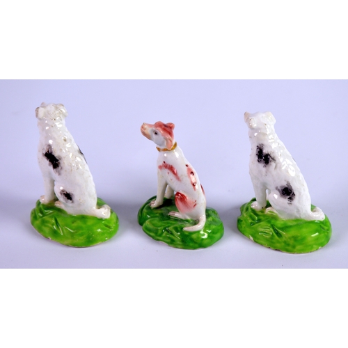 131 - THREE NINETEENTH CENTURY STAFFORDSHIRE PORCELAIN MODELS OF SEATED DOGS, including a PAIR WITH BLACK ... 