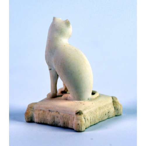 133 - NINETEENTH CENTURY ROCKINGHAM BISCUIT PORCELIAN MODEL OF A SEATED CAT, on an oblong tasselled cushio... 