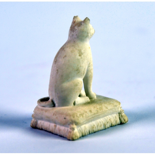 134 - NINETEENTH CENTURY ROCKINGHAM BISCUIT PORCELIAN MODEL OF A SEATED CAT, on an oblong tasselled cushio... 