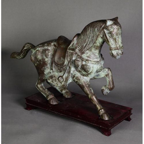 176 - ORIENTAL ANTIQUE STYLE PATINATED BRONZE MODEL OF A CEREMONIAL HORSE, modelled in trotting pose, 11 ¼... 