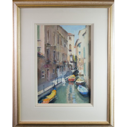 129 - BOB RICHARDSON (1938) PASTELVenetian canal scene with moored boats and a gondola in the foreground S... 