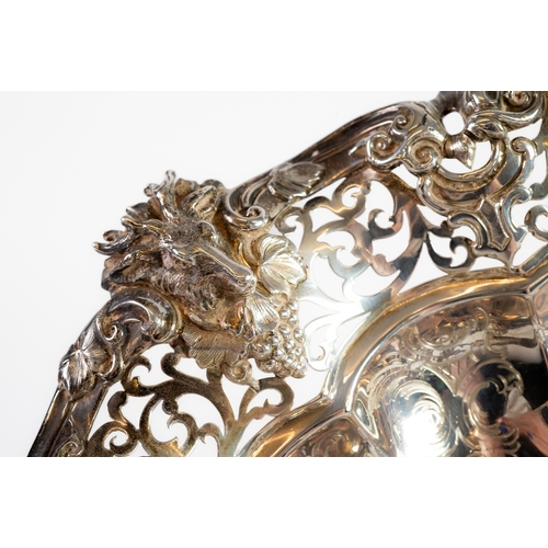 476 - VICTORIAN EMBOSSED AND PIERCED SILVER SWING HANDLED CAKE BASKET, of circular footed form with floral... 