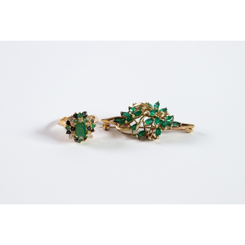 135 - GOLD COLOURED METAL SPRAY BROOCH set with three small diamonds and nineteen lozenge shaped green sto... 