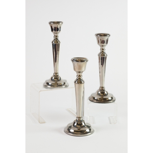 473 - SET OF THREE WEIGHTED SILVER CANDLESTICKS, each of tapering form with beaded border and circular bas... 