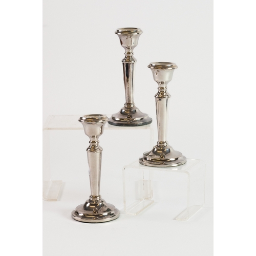 475 - SET OF THREE WEIGHTED SILVER DRESSING TABLE CANDLESTICKS, each of tapering form with beaded border a... 