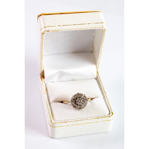 124 - DIAMOND DAISY CLUSTER RING with raised centre diamond, approximately 0.50ct, with surround of eight ... 