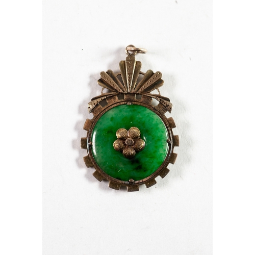 113 - CHINESE GOLD PENDANT, claw set with a disc of green jade with gold flower to the centre on each side... 