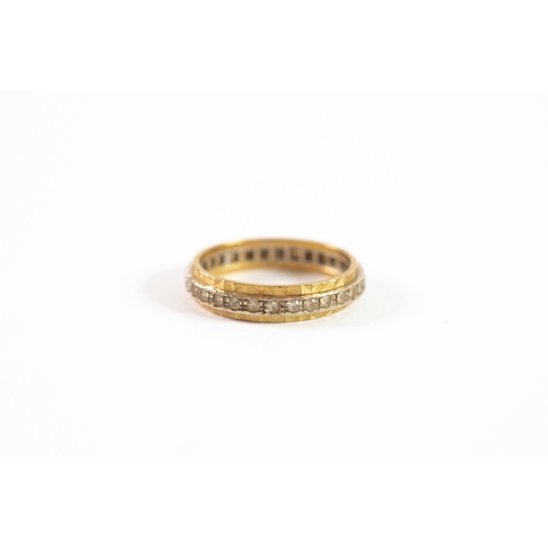 134 - 18ct YELLOW AND WHITE GOLD FACETED ETERNITY RING set with tiny white stones, 4.8gms, ring size 'U/V'... 