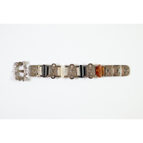 136 - VICTORIAN SILVER AND BANDED AGATE BUCKLE BRACELET, five foliate scroll engraved curved and pierced p... 