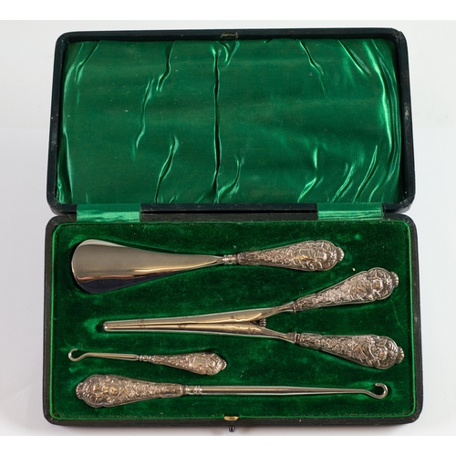 485 - EDWARD VII CASED FOUR PIECE TRAVELLING SET WITH FILLED SILVER HANDLES, comprising; TWO BUTTON HOOKS,... 